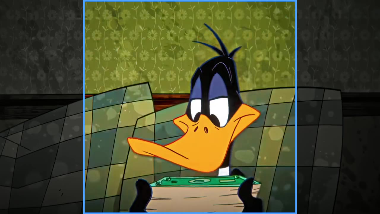 An untouched 16:9 frame from the source video, with the vertical crop region outlined in blue and the rest of the frame dimmed.